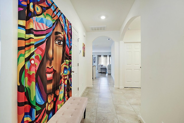 hall with light tile patterned floors