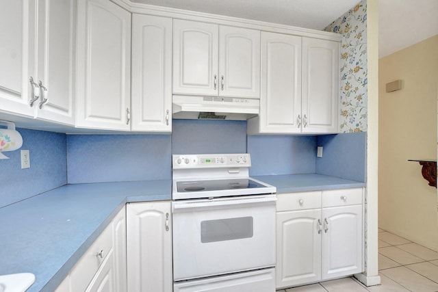 kitchen with white cabinetry, white electric stove, and light tile patterned floors