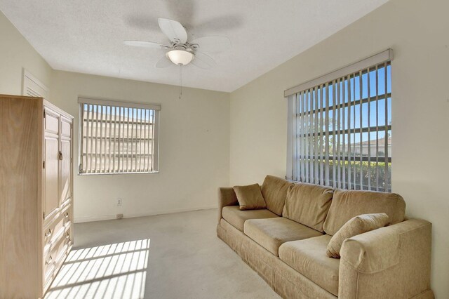 living room with light carpet, a textured ceiling, and ceiling fan