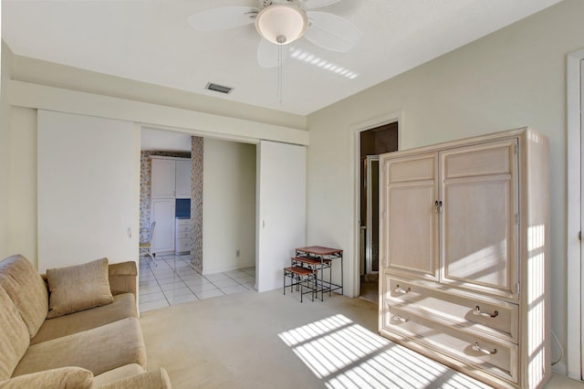 living room with light tile patterned floors and ceiling fan