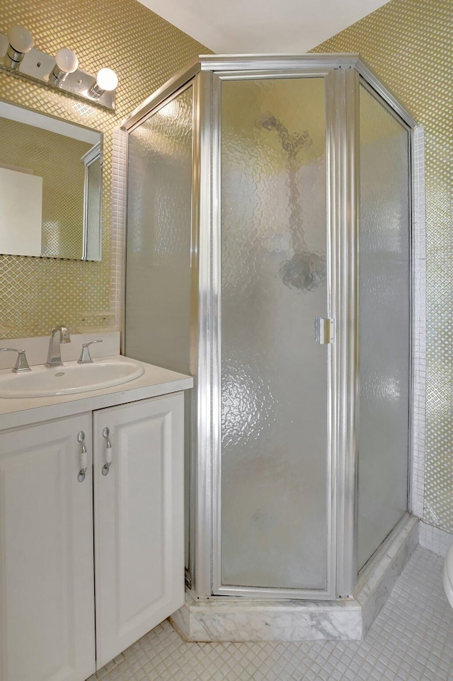 bathroom featuring vanity and an enclosed shower