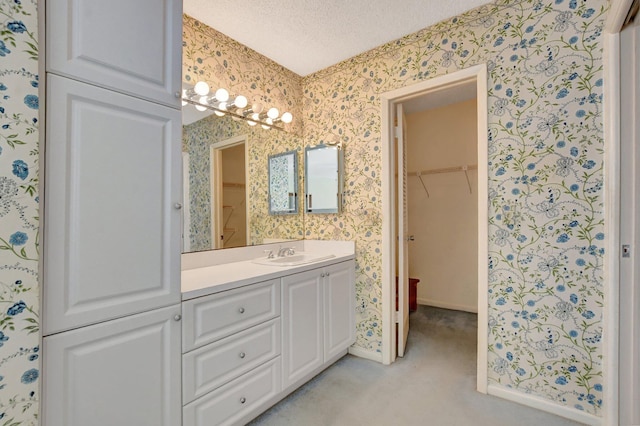 bathroom with vanity and a textured ceiling