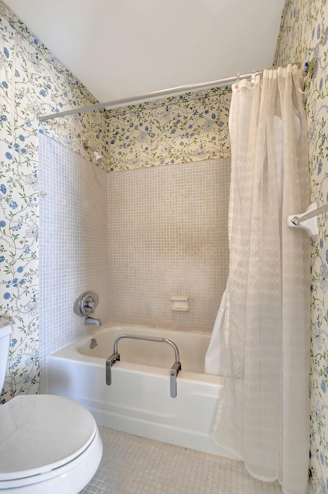 bathroom with shower / bath combination with curtain, tile patterned floors, and toilet