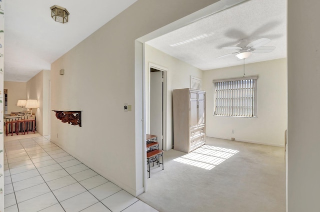 hall featuring light tile patterned floors