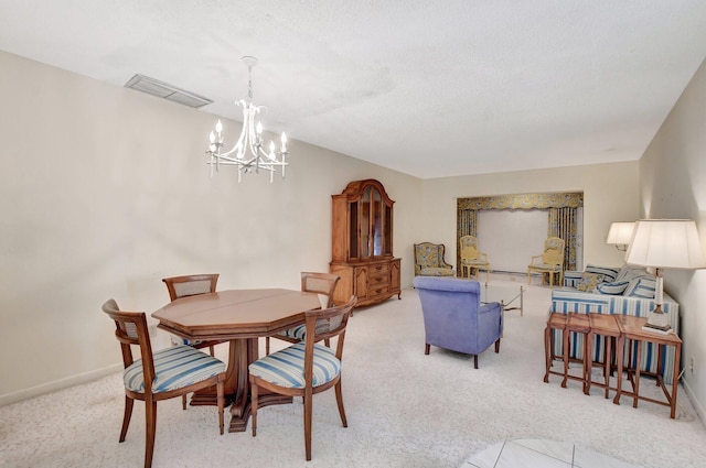 dining room with an inviting chandelier and light carpet