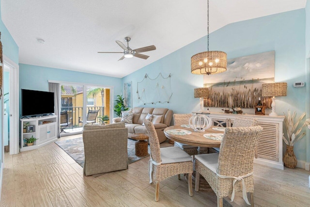 dining area featuring vaulted ceiling, ceiling fan, and light hardwood / wood-style flooring