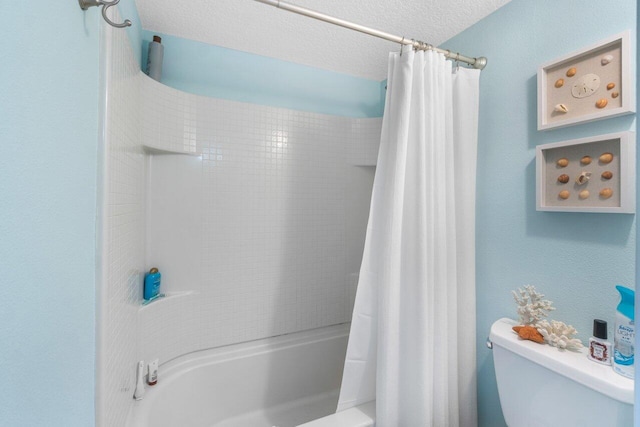 bathroom with toilet, shower / bath combo, and a textured ceiling