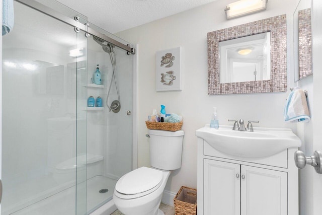 bathroom with a textured ceiling, a shower with door, toilet, and vanity