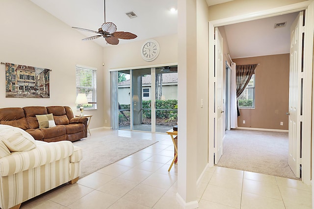 living room with light tile patterned flooring, ceiling fan, and vaulted ceiling