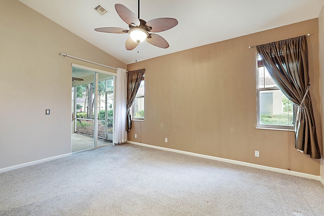 empty room with ceiling fan, carpet flooring, and vaulted ceiling