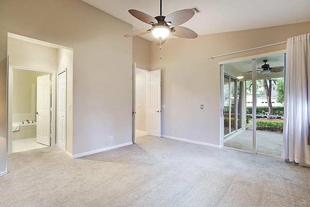 unfurnished bedroom with lofted ceiling, access to exterior, light colored carpet, and ceiling fan