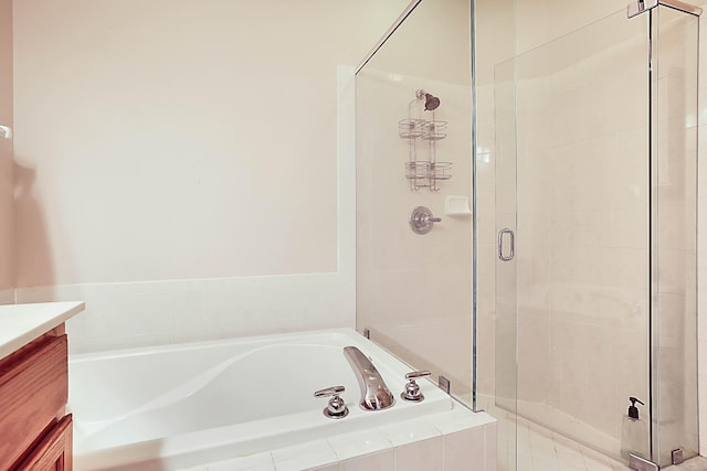 bathroom featuring vanity and separate shower and tub