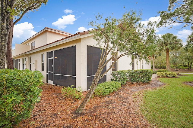 view of home's exterior with a sunroom