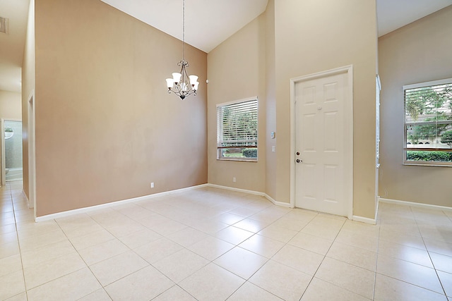 interior space featuring a wealth of natural light, a chandelier, high vaulted ceiling, and light tile patterned floors