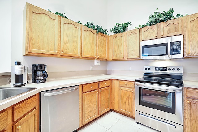 kitchen with appliances with stainless steel finishes and light tile patterned floors