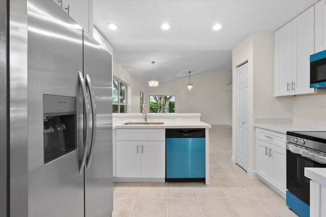 kitchen with stainless steel appliances, vaulted ceiling, white cabinets, and decorative light fixtures