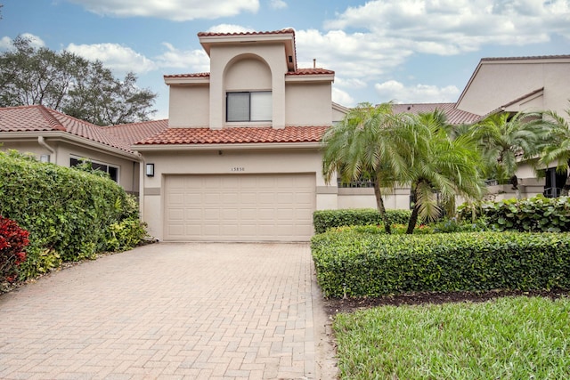 mediterranean / spanish-style house with a garage