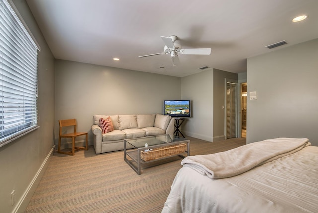 living room featuring light colored carpet and ceiling fan