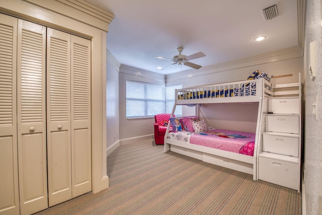 bedroom with ceiling fan, ornamental molding, and carpet