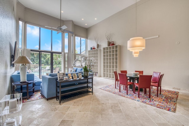 living room featuring ornamental molding and a high ceiling