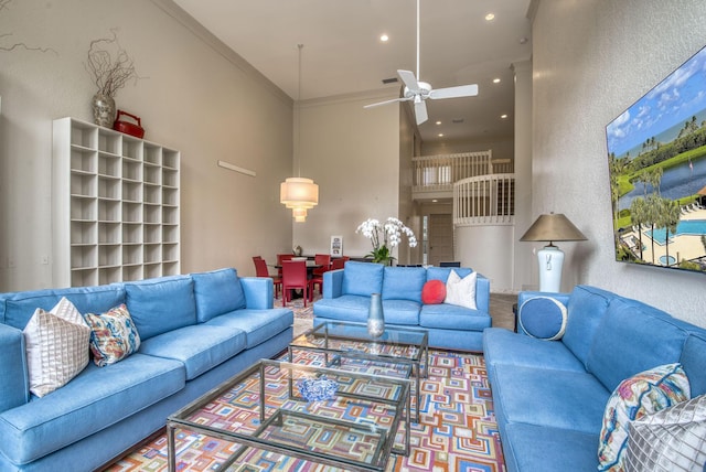 living room with crown molding and ceiling fan