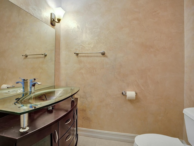 bathroom with vanity, tile patterned flooring, and toilet