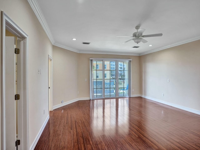 spare room with wood-type flooring, ceiling fan, and crown molding