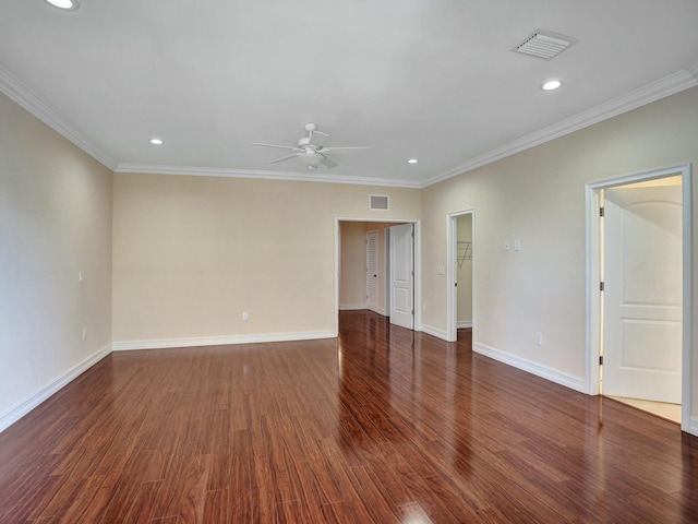 empty room featuring dark wood-type flooring, ceiling fan, and ornamental molding