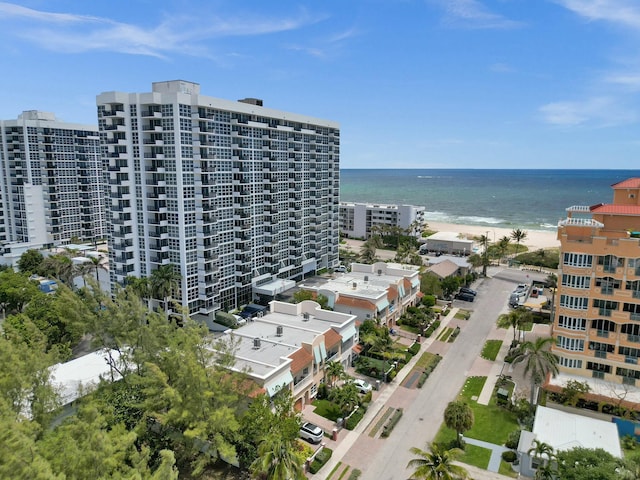 drone / aerial view featuring a water view and a view of the beach