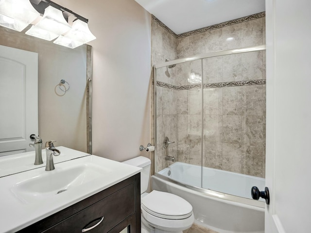 full bathroom featuring vanity, toilet, and combined bath / shower with glass door