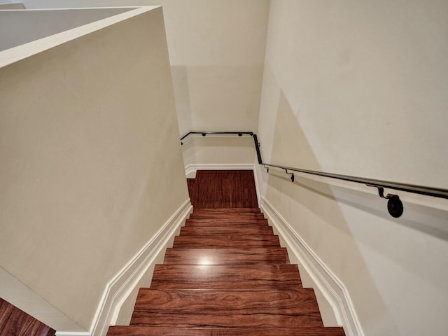 staircase with hardwood / wood-style floors