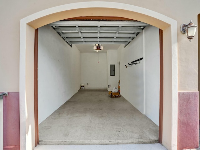 garage with a garage door opener and electric panel