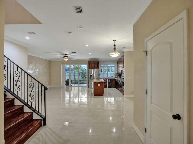 stairway featuring crown molding and ceiling fan