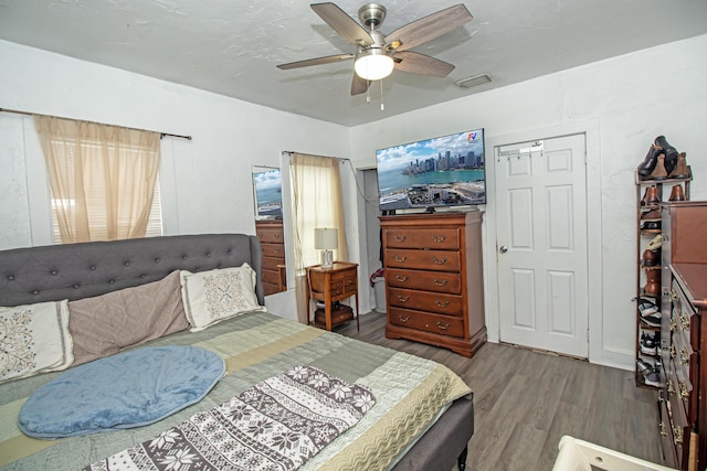 bedroom with hardwood / wood-style floors and ceiling fan