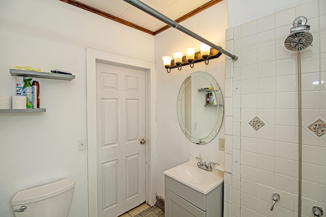 bathroom with ornamental molding, vanity, and toilet