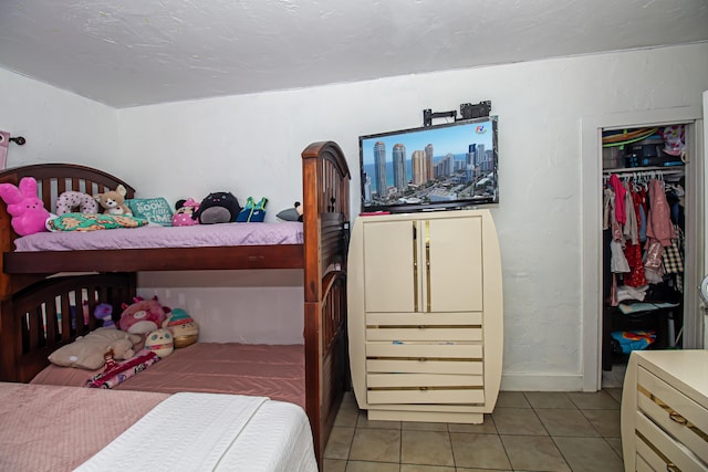 bedroom featuring light tile patterned floors and a closet