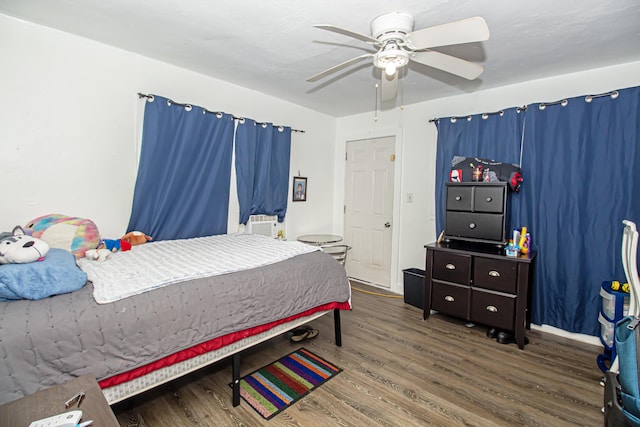 bedroom featuring wood-type flooring, cooling unit, and ceiling fan