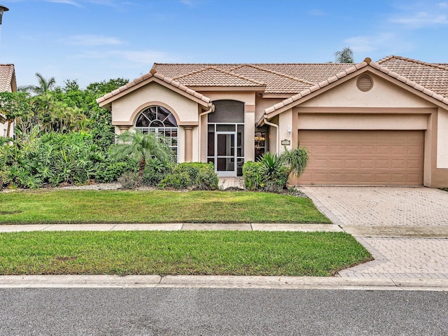 view of front of house featuring a garage and a front lawn