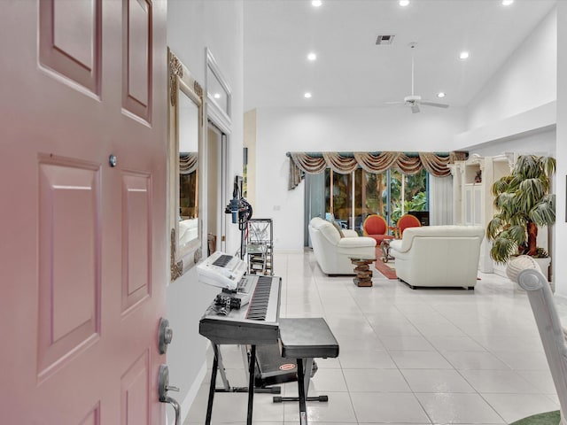 living room featuring ceiling fan, lofted ceiling, and light tile patterned flooring