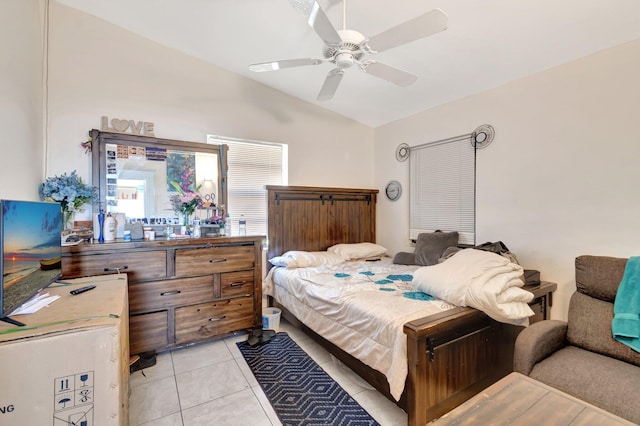 bedroom featuring light tile patterned flooring, vaulted ceiling, and a ceiling fan