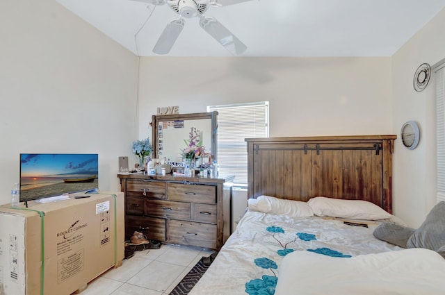 bedroom with ceiling fan and light tile patterned floors