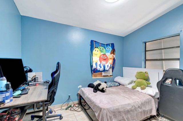 bedroom featuring light tile patterned flooring and baseboards