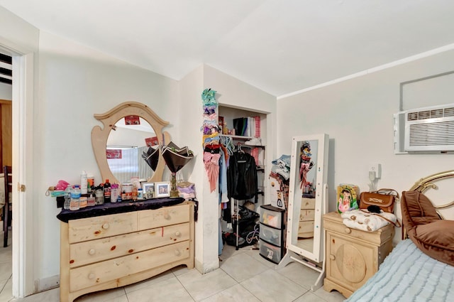 bedroom with light tile patterned flooring and an AC wall unit