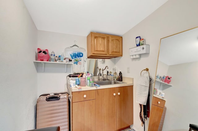 kitchen featuring light countertops, a sink, and open shelves