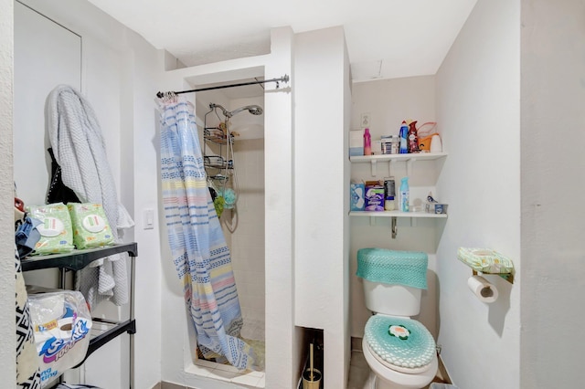 bathroom featuring toilet and a stall shower
