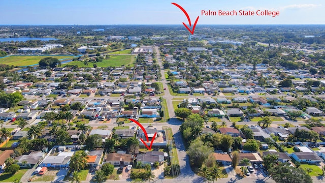 bird's eye view featuring a residential view and a water view
