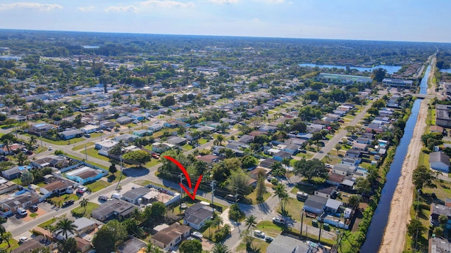 drone / aerial view featuring a residential view and a water view