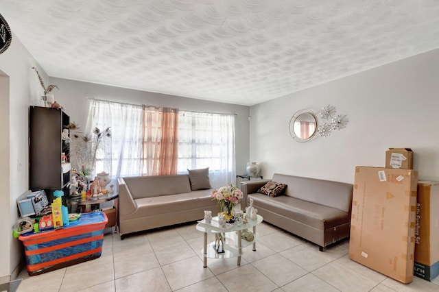living room featuring a textured ceiling and light tile patterned floors