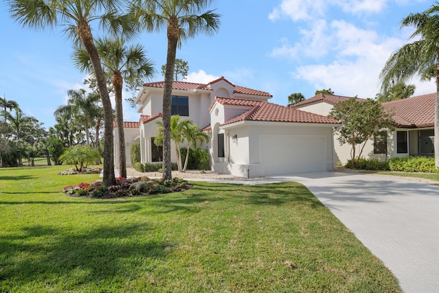 mediterranean / spanish-style house featuring a garage and a front yard