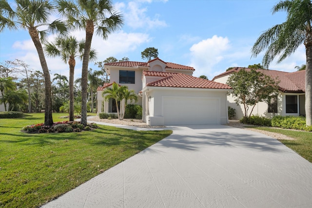 mediterranean / spanish house with a garage and a front lawn